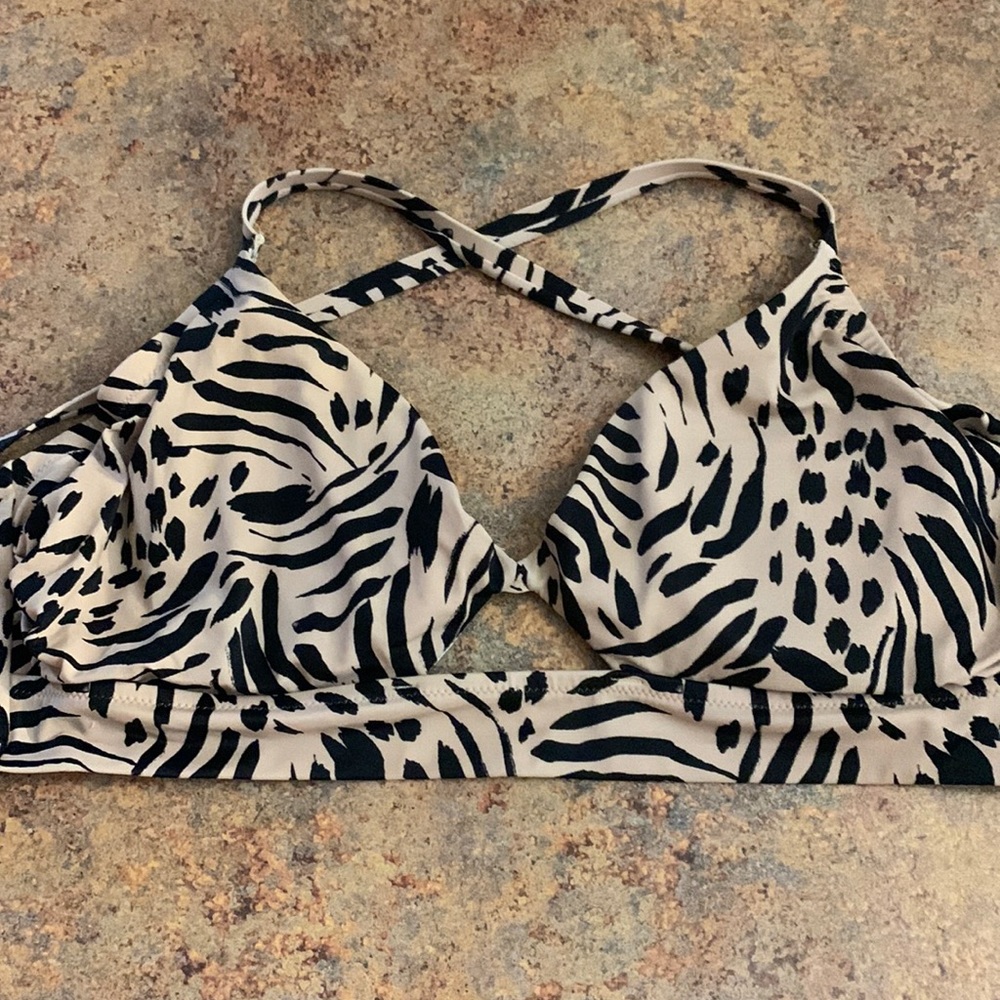 Printed bathing suit top. Criss-cross back. Has wire. Worn twice. No stains.